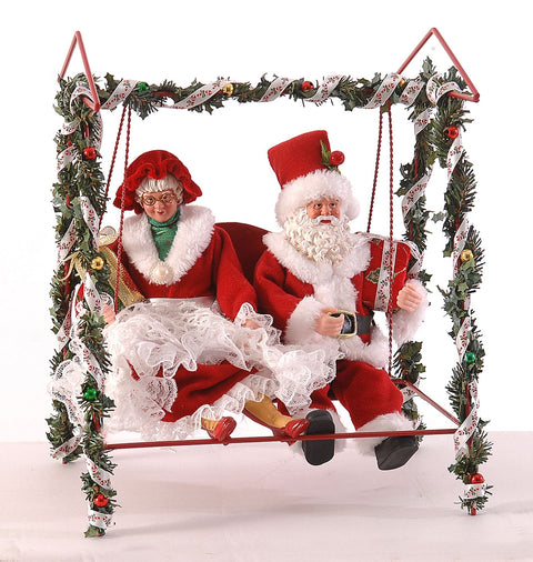 Figurine Vetur représentant le Père Noël et la Mère Noël assis sur une balançoire, en résine, 28 cm