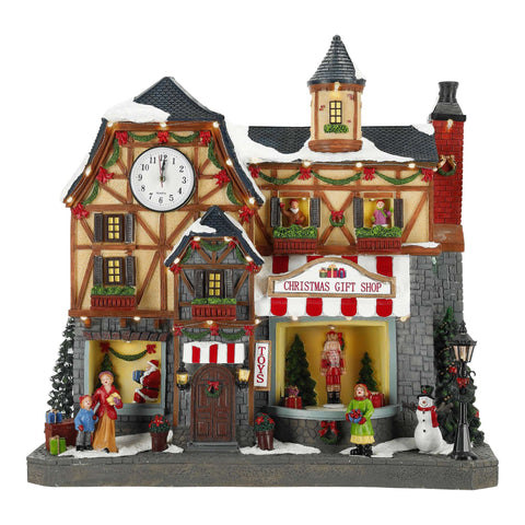 TIMSTOR Edificio natalizio negozio con luci e movimento poliresina 43x22,5x41 cm