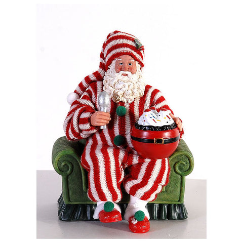 Figurine VETUR Père Noël sur fauteuil en pyjama avec glace en résine et tissu H23 cm