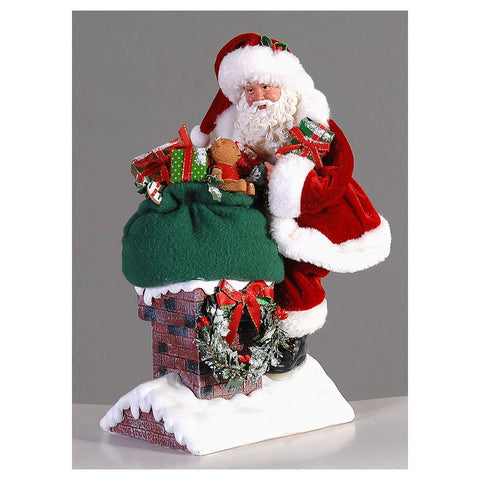 Figurine VETUR Père Noël avec cheminée et cadeaux en résine et tissu H28 cm