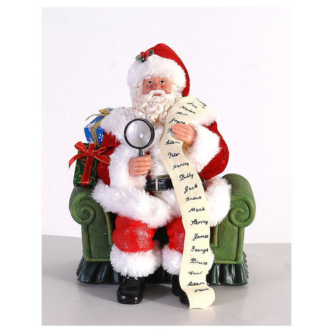 VETUR Figurine Père Noël sur fauteuil avec cadeaux et liste en résine et tissu H23 cm